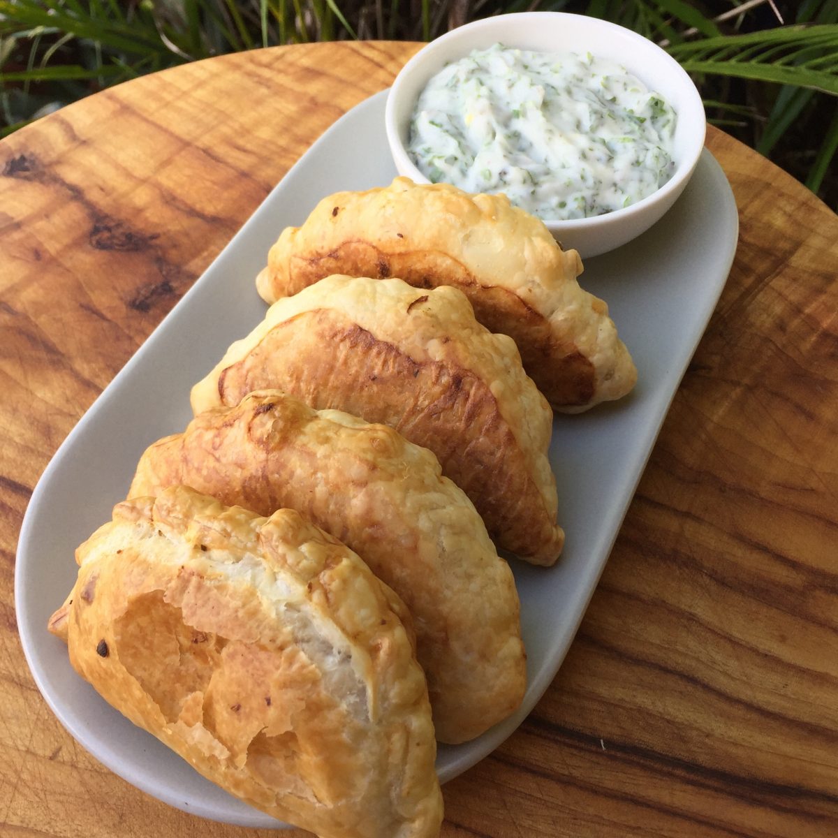 Crunchy pillows of puff pastry filled with Indian curry spiced vegetables served with a bowl of Mint and coriander chutney dipping sauce