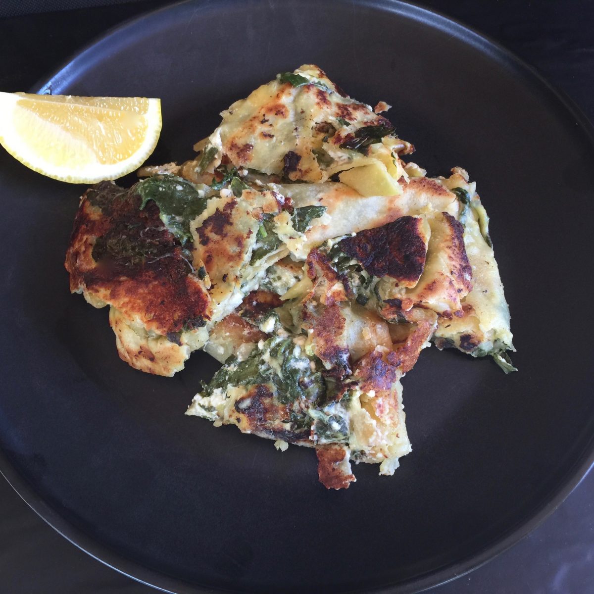 A pillow of cheesy spinach and feta mix containing mozzarella cheese, cumin, paprika, cayenne and black pepper in a tasty easy to make flat bread dressing with a tangy lemon juice by cooking meals for one