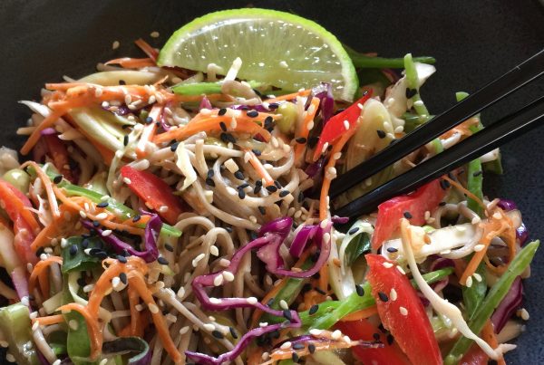 This delicious salad is healthy vibrant and colouful, full of crunchy red and green cabbage, carrots, capsicum, and soba noodles dressed in a delicious Japanese Roasted sesame, lime and soy dressing. Served in a salad bowl with chopped sticks on the side