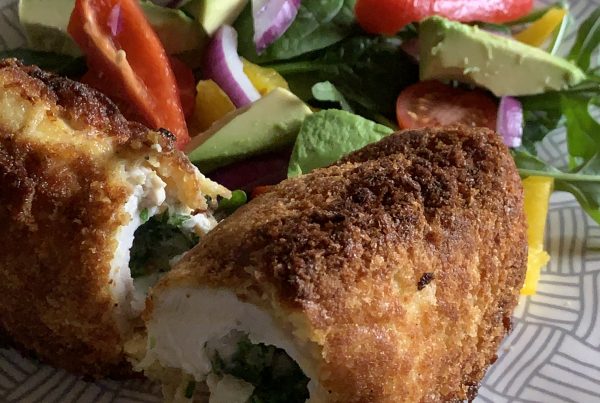Crunchy-Crispy Chicken breast stuffed with a tangy-garlic-butter rolled and coated in panko breadcrumbs.Then Then pan fried to a golden crunch and cooked in the oven. served with a crisp salad