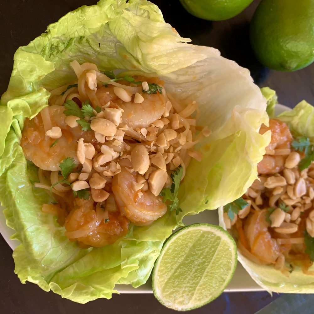 Prawn Pad Thai Lettuce Cups by cookongmealsforone.com a delicious combinations of prawns crisp carrots and green onions coriander and pad thai noodles dressing in a yummy pad thai paste nested in 2 crispy lettuce leaves sprinkles with chopped peanuts and squeeze of lime